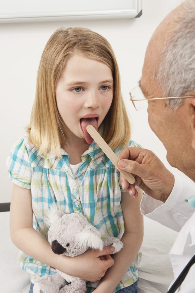 young girl getting a physical for school