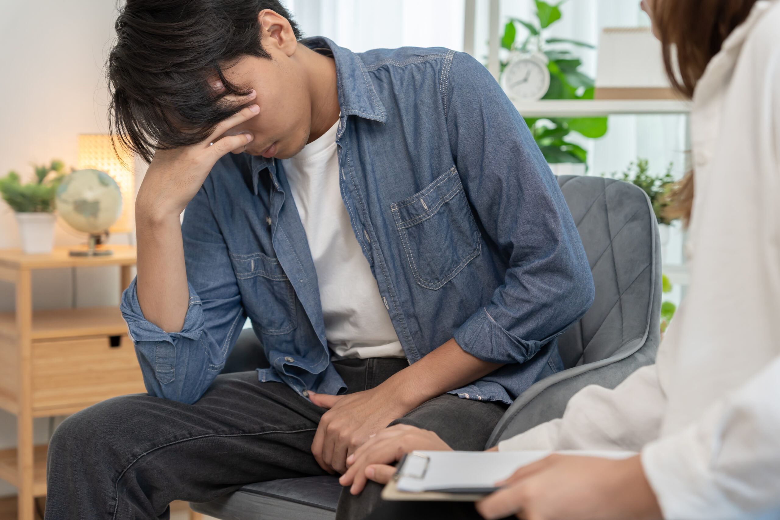 Man feeling discomfort and consulting doctor