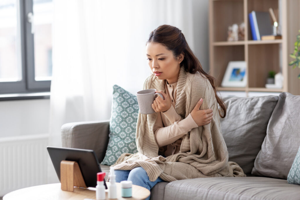 sick woman having video call on tablet pc at home